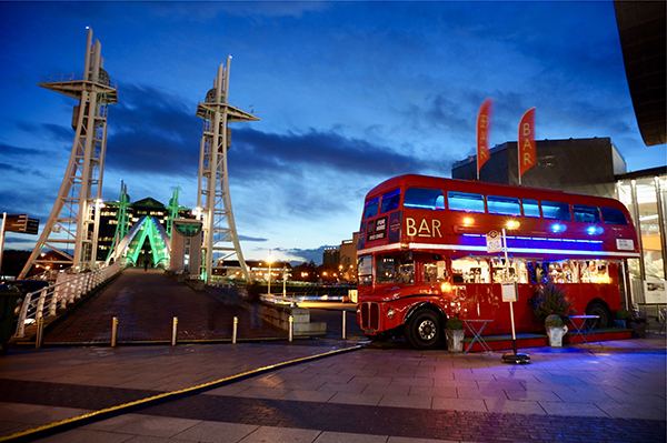 The Big Red Bus Bar lit up at night