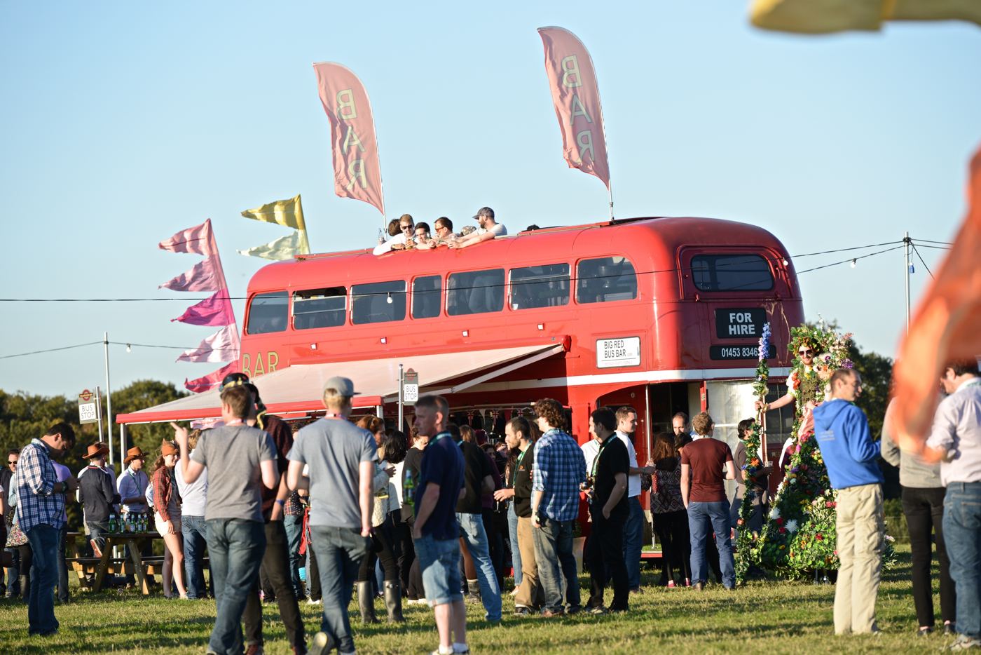 Big Red Bus Bar serving guests at a sunny festival