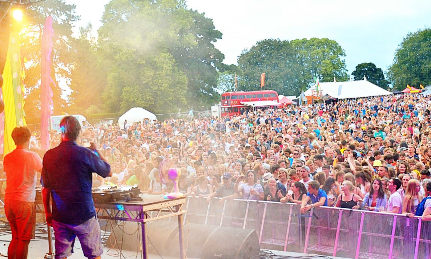 Crowd in front of a lit stage at a live event